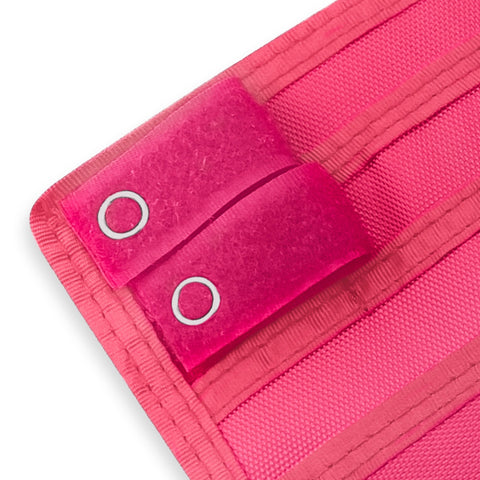 Close-up of a Hot Pink fabric with grommets on a white background