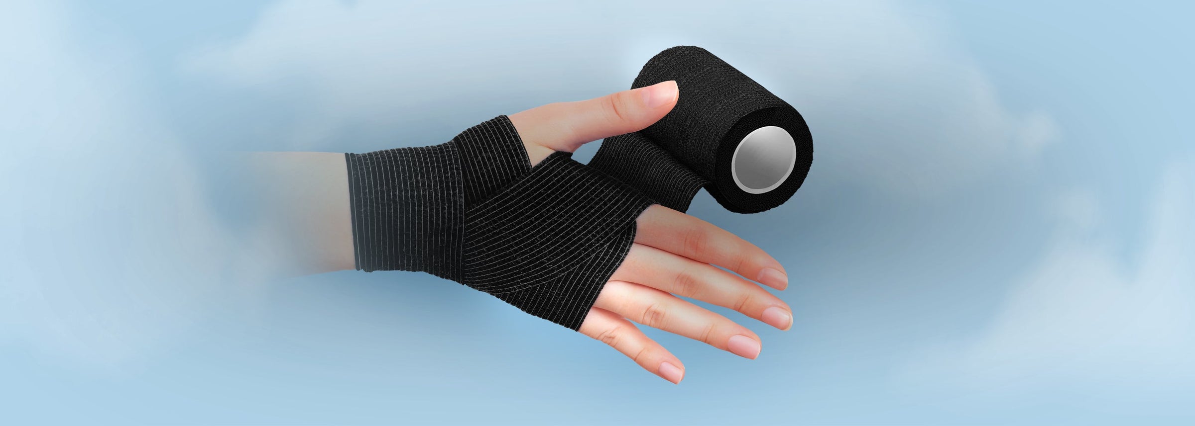 A hand being wrapped with a black elastic cohesive bandage roll, representing the Elastic Bandages & Compression collection.