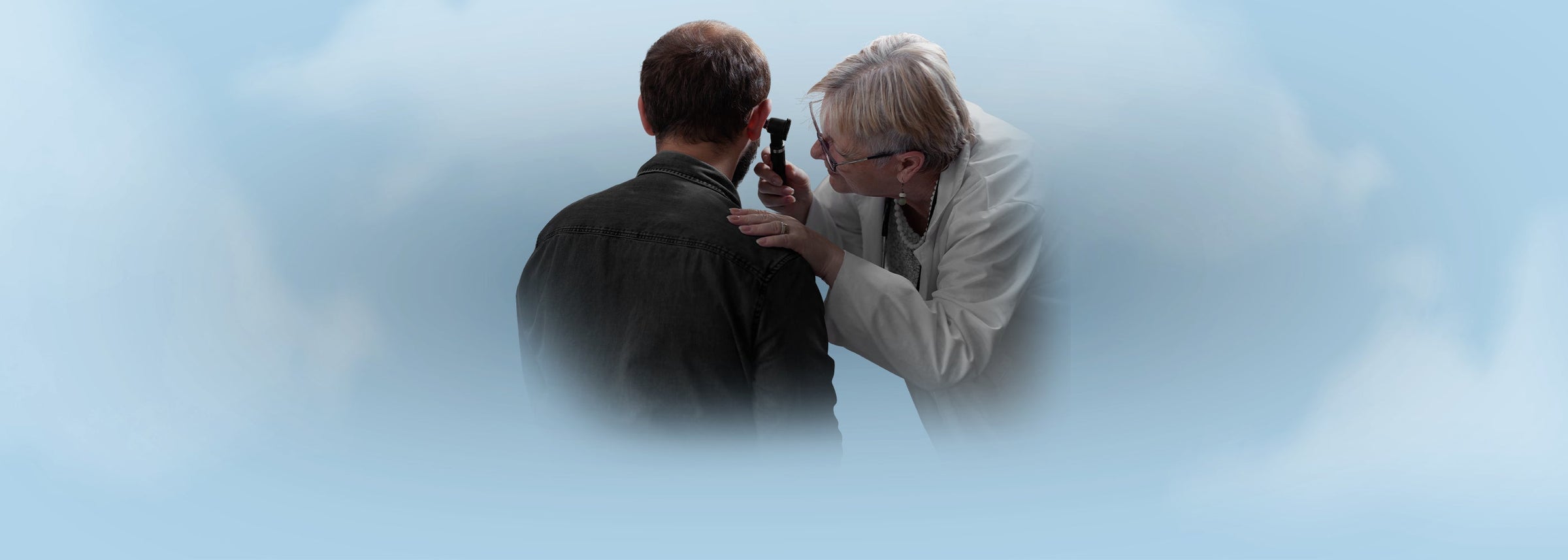 A healthcare professional using a medical otoscope to perform an ear examination on a patient, representing the Medical Otoscopes & ENT Diagnostic Sets collection.