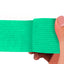 Turquoise adhesive bandage wrap held by a hand on a white background