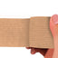 Tan adhesive bandage wrap held by a hand on a white background
