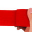 Red adhesive bandage wrap held by a hand on a white background