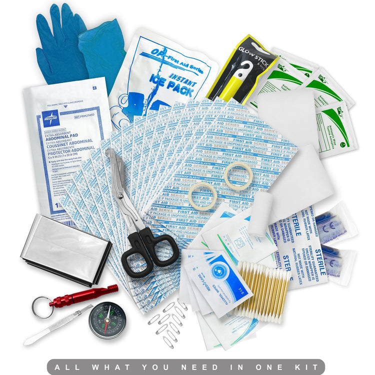 A close-up overhead view of various first aid supplies, including blue gloves, an abdominal pad, trauma shears, an instant ice pack, safety pins, a red whistle/compass, gauze, cotton tip applicators, and various antiseptic wipes, under the title "ALL WHAT YOU NEED IN ONE KIT."
