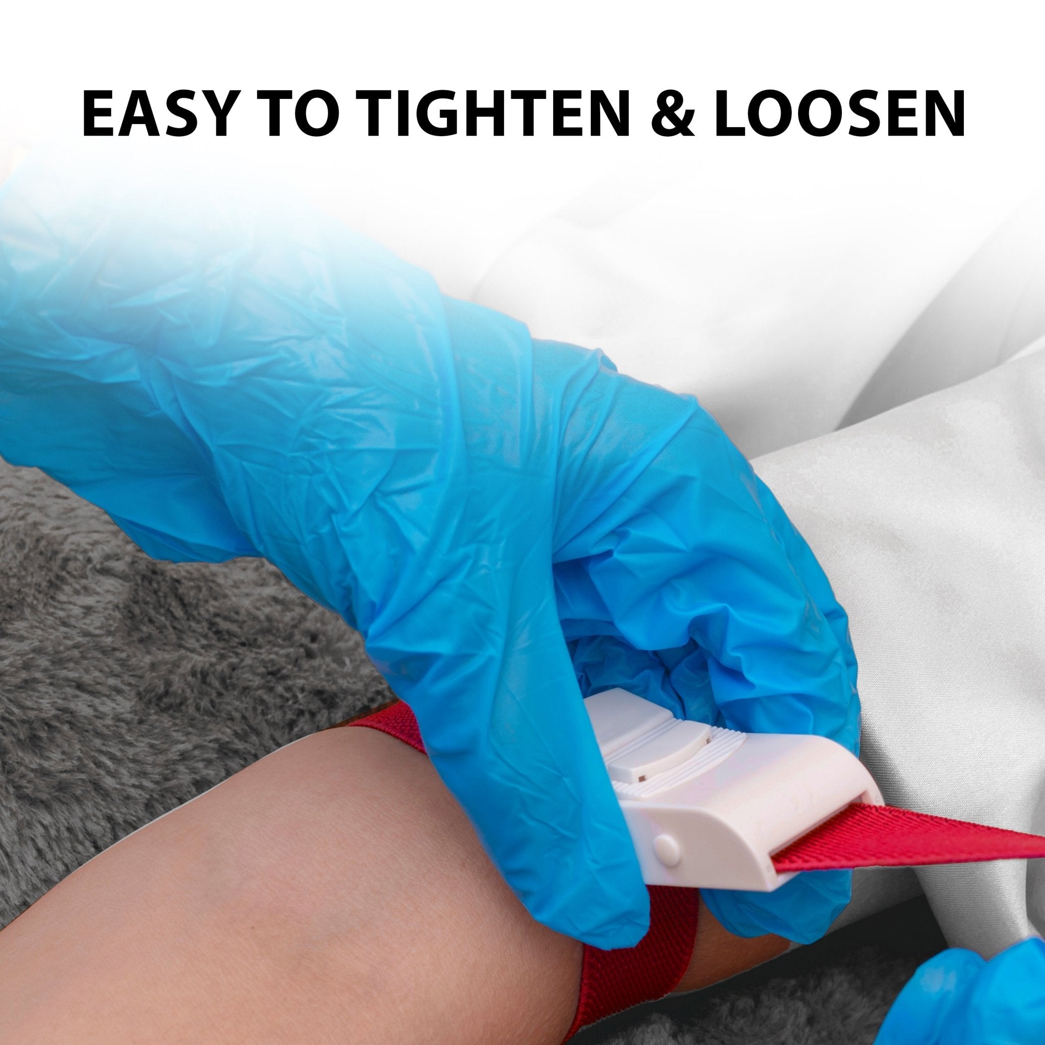 Demonstrating how to tighten and loosen a red medical tourniquet with one hand during a clinical procedure.