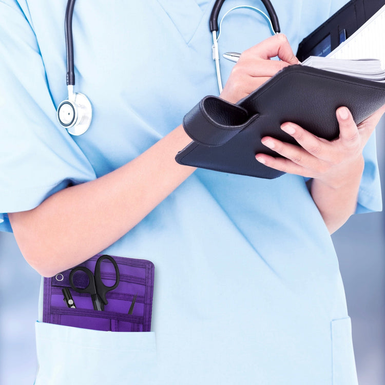 A nurse jotting down notes during her shift, with a sleek organizer pouch visibly tucked into her scrub pocket—ready with essential tools for quick access.