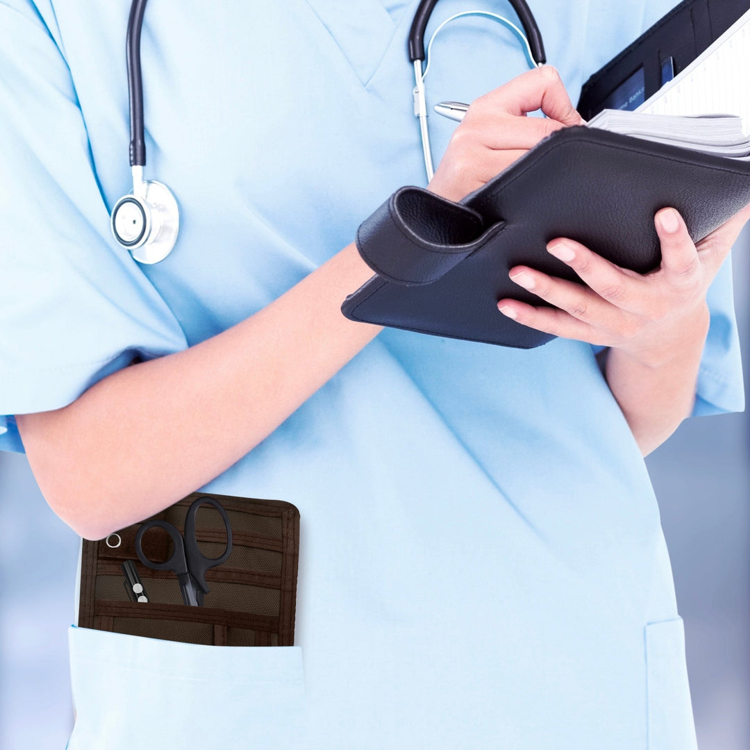 A nurse jotting down notes during her shift, with a sleek organizer pouch visibly tucked into her scrub pocket—ready with essential tools for quick access.