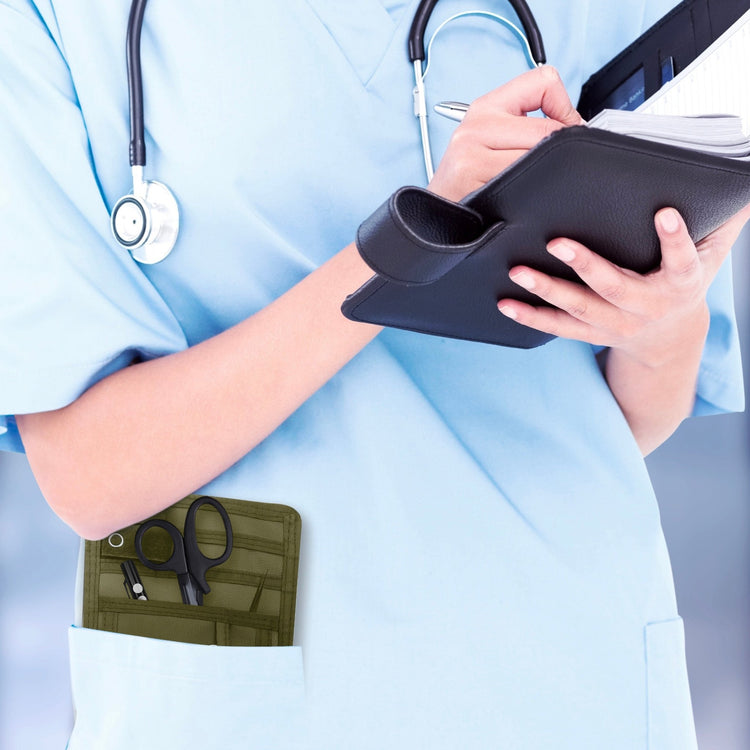 A nurse jotting down notes during her shift, with a sleek organizer pouch visibly tucked into her scrub pocket—ready with essential tools for quick access.
