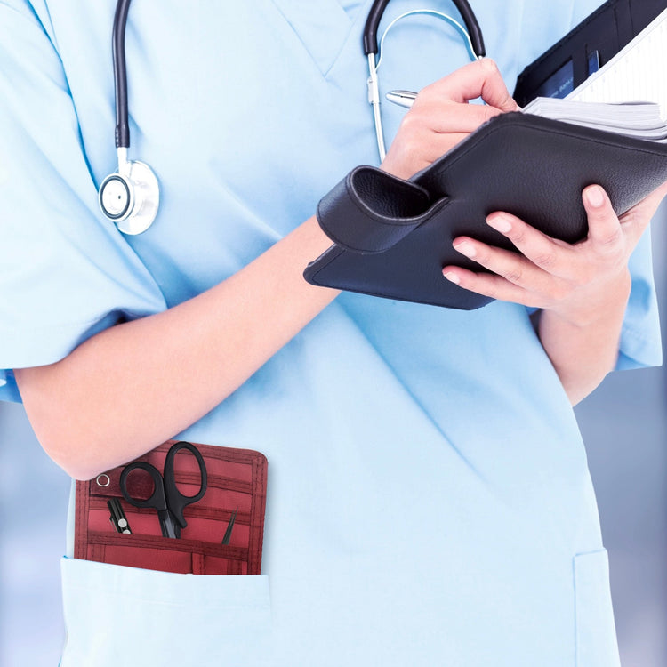 A nurse jotting down notes during her shift, with a sleek organizer pouch visibly tucked into her scrub pocket—ready with essential tools for quick access.