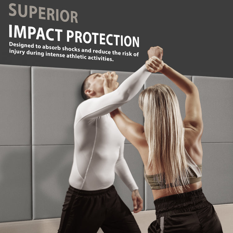 A man and woman practicing self-defense techniques against a wall lined with gray pads, accompanied by text reading "SUPERIOR IMPACT PROTECTION" designed to reduce injury risk.