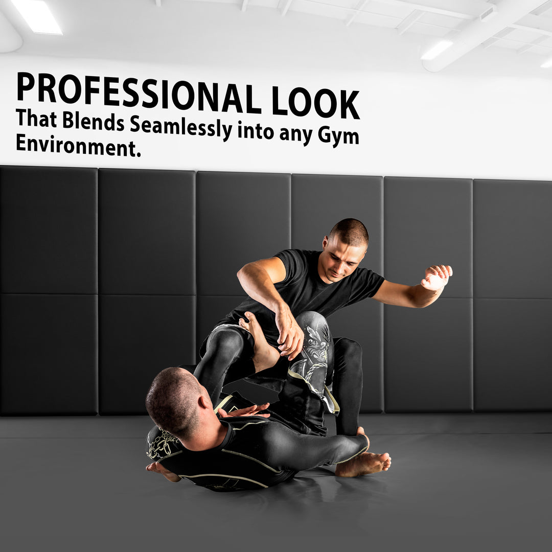 Two athletes grappling on a gym floor with the walls behind them covered in black protective padding, accompanied by text stating "PROFESSIONAL LOOK That Blends Seamlessly into any Gym Environment".