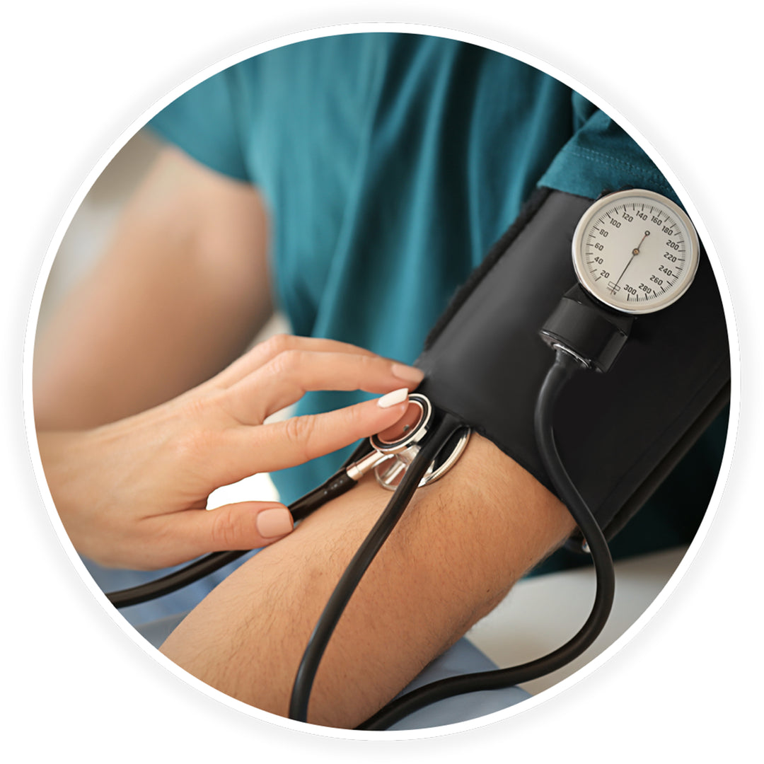 A close-up of a medical professional's hands holding a stethoscope against a patient's inner elbow, just below a fastened black blood pressure cuff with a visible gauge.