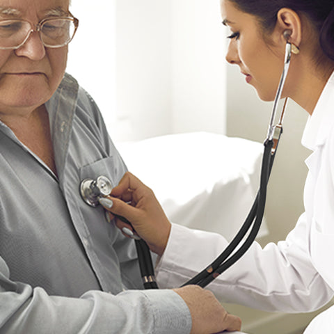 Doctor using a stethoscope on an elderly patient in a clinical setting