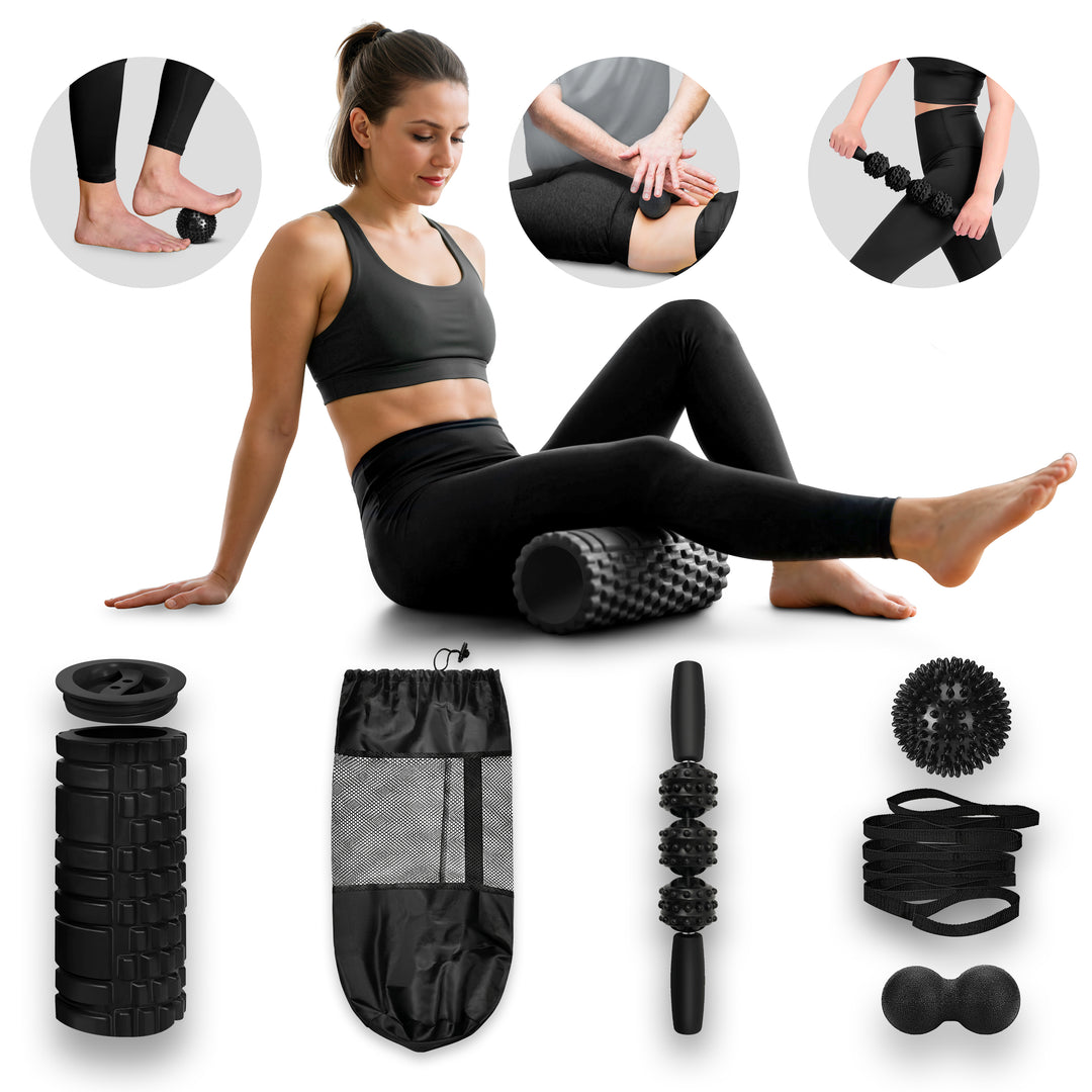 A comprehensive black muscle recovery and exercise kit displayed against a white background. At the top, a smiling woman in black athletic wear uses a textured grid foam roller on her glutes. Three insets show varied uses: a foot on a spiky ball, using a peanut ball on a thigh, and using a roller stick. Below, the separate kit items include a grid foam roller, mesh bag, muscle roller stick, spiky ball, stacked resistance bands, and a peanut ball.