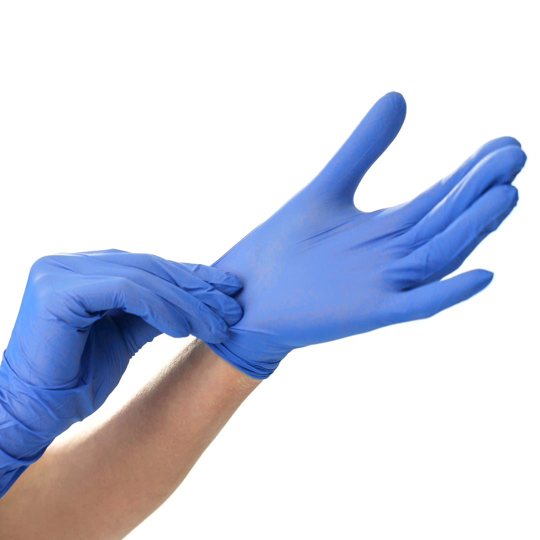 A pair of hands demonstrating the process of putting on blue disposable nitrile medical gloves against a white background.