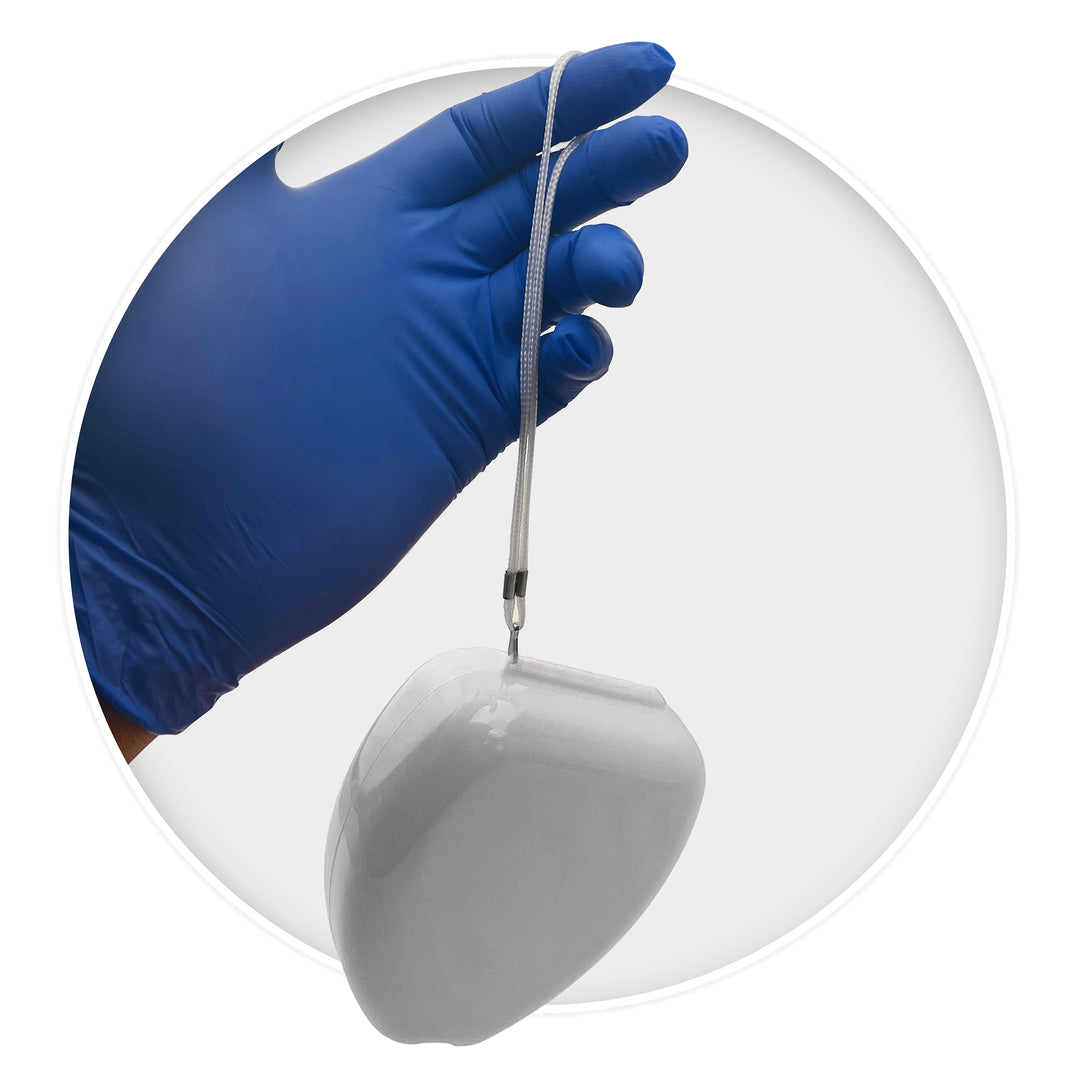A hand wearing a blue nitrile glove holding a white CPR mask case suspended by its white wrist strap.