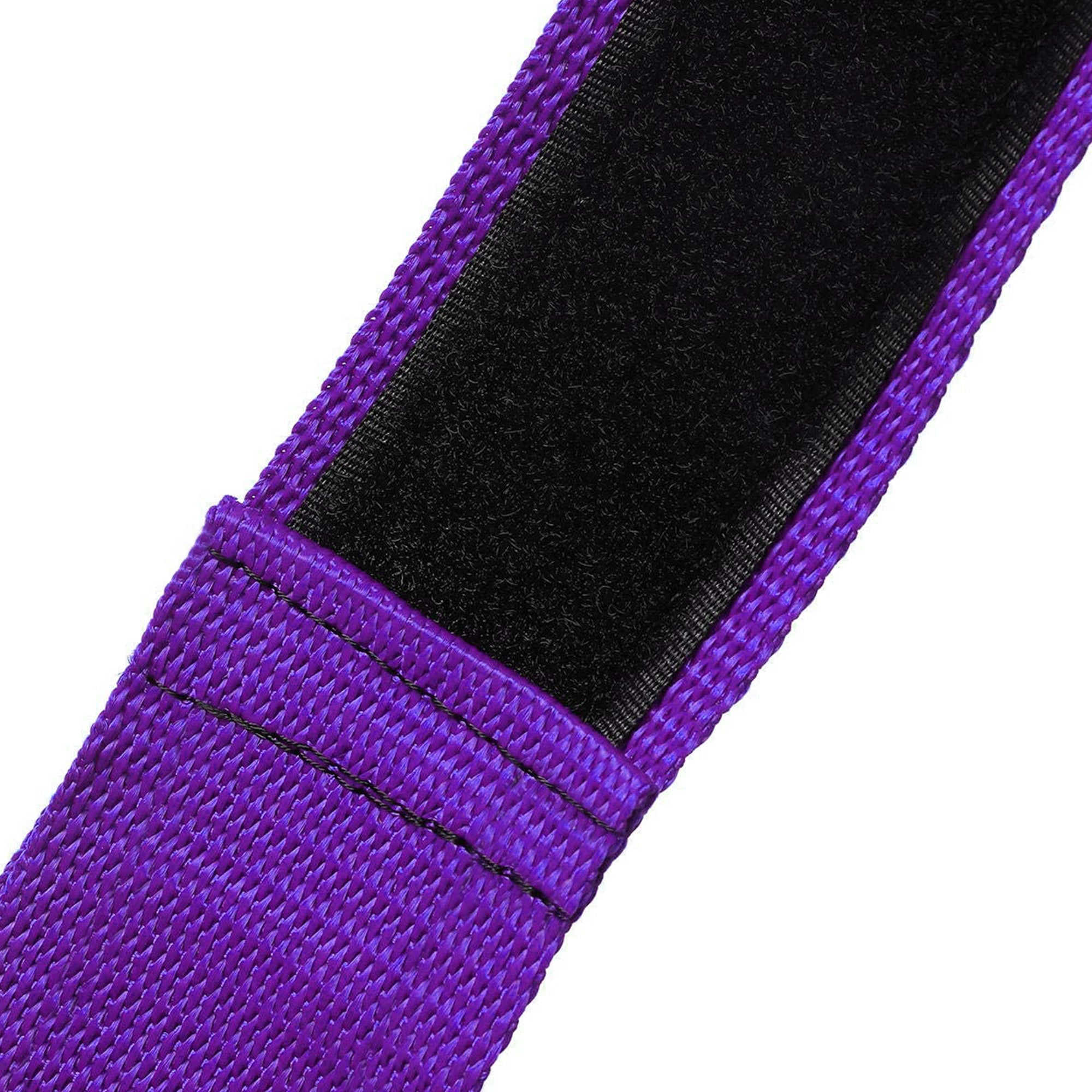 An extreme close-up of a purple nylon strap, showing the durable heavy-duty stitching and the texture of the black hook-and-loop (Velcro) fastening material.