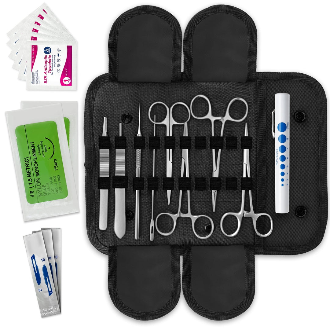 A flat-lay view of an open military-style medical kit. A black canvas pouch with elastic loops holds various stainless steel tools including hemostats, scissors, forceps, a probe, a scalpel handle, and a pen light. Sterile suture packets and antiseptic wipes are placed to the side.