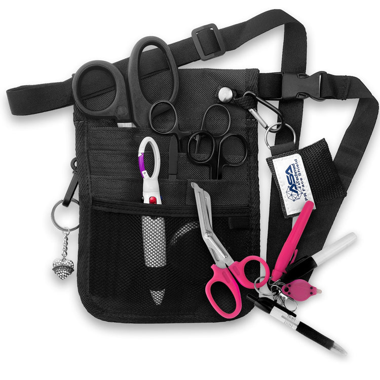 A fully assembled black nursing organizer pouch attached to a black adjustable waist strap. The pouch is filled with medical supplies, including black-handled trauma shears, hemostats, a CPR face shield keychain, a retractable tape measure, and various writing instruments. A decorative black heart charm hangs from the side.
