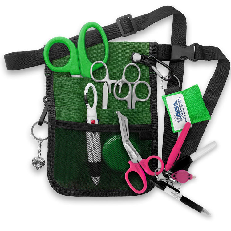 A fully assembled green nursing organizer pouch attached to a black adjustable waist strap. The pouch is filled with medical supplies, including green-handled trauma shears, hemostats, a CPR face shield keychain, a retractable tape measure, and various writing instruments. A decorative green heart charm hangs from the side.