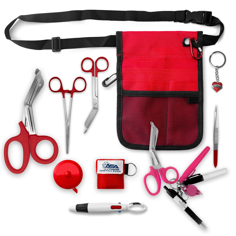 A top-down view displaying all items included in the kit laid out separately: the red organizer pouch, adjustable black belt, large red trauma shears, smaller bandage scissors, straight hemostats, red tape measure, CPR face shield keychain, tweezers, a 4-color carabiner pen, permanent markers, and a rhinestone heart charm.