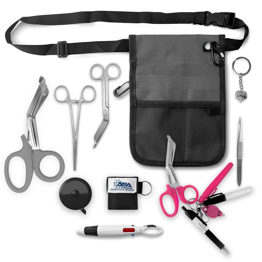 A top-down view displaying all items included in the kit laid out separately: the gray organizer pouch, adjustable black belt, large gray trauma shears, smaller bandage scissors, straight hemostats, gray tape measure, CPR face shield keychain, tweezers, a 4-color carabiner pen, permanent markers, and a rhinestone heart charm.