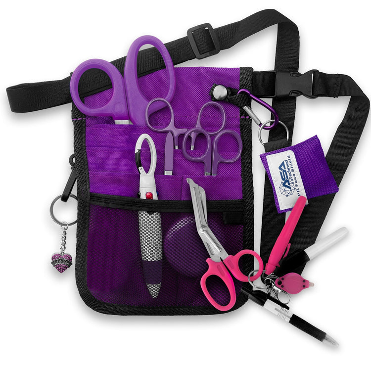 A fully assembled purple nursing organizer pouch attached to a black adjustable waist strap. The pouch is filled with medical supplies, including purple-handled trauma shears, hemostats, a CPR face shield keychain, a retractable tape measure, and various writing instruments. A decorative purple heart charm hangs from the side.