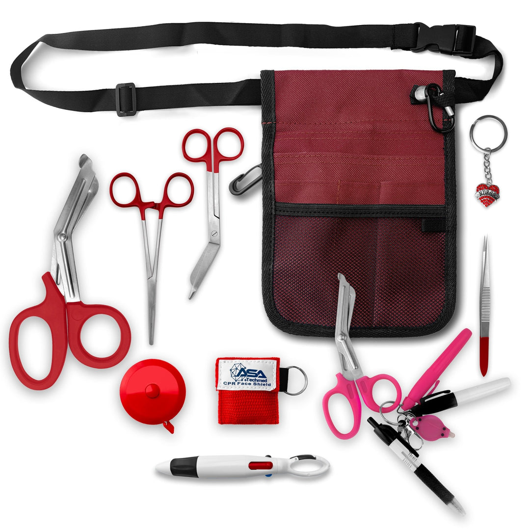A top-down view displaying all items included in the kit laid out separately: the burgundy organizer pouch, adjustable black belt, large burgundy trauma shears, smaller bandage scissors, straight hemostats, burgundy tape measure, CPR face shield keychain, tweezers, a 4-color carabiner pen, permanent markers, and a rhinestone heart charm.
