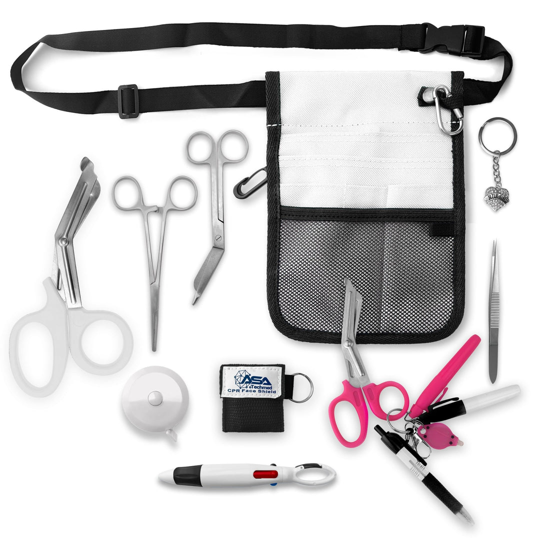 A top-down view displaying all items included in the kit laid out separately: the white organizer pouch, adjustable black belt, large white trauma shears, smaller bandage scissors, straight hemostats, white tape measure, CPR face shield keychain, tweezers, a 4-color carabiner pen, permanent markers, and a rhinestone heart charm.