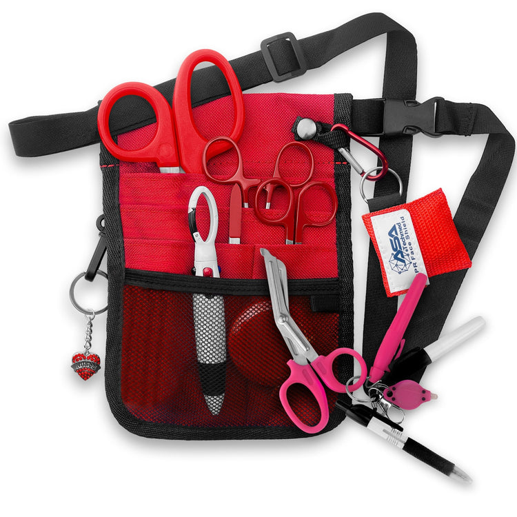 A fully assembled red nursing organizer pouch attached to a black adjustable waist strap. The pouch is filled with medical supplies, including red-handled trauma shears, hemostats, a CPR face shield keychain, a retractable tape measure, and various writing instruments. A decorative red heart charm hangs from the side.