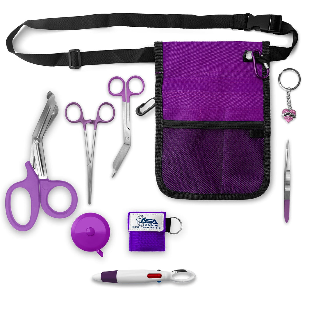 A top-down view of the complete nursing kit contents spread out. Items include the purple waist organizer with black belt, purple-handled trauma shears, stainless steel bandage scissors, straight hemostat forceps, a purple round retractable tape measure, a purple square CPR face shield keychain, metal tweezers, a multi-color pen, permanent markers on a clip, and a rhinestone heart charm reading "Nurse".