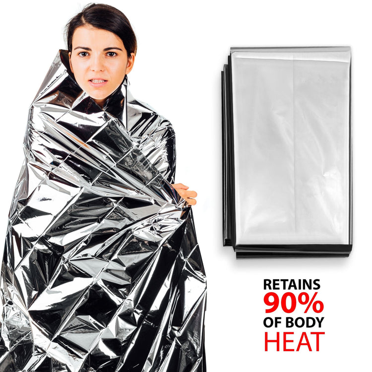 A woman standing wrapped in a silver foil thermal emergency blanket next to a neat, folded package of the same blanket. Large text on the right reads "Retains 90% of Body Heat."