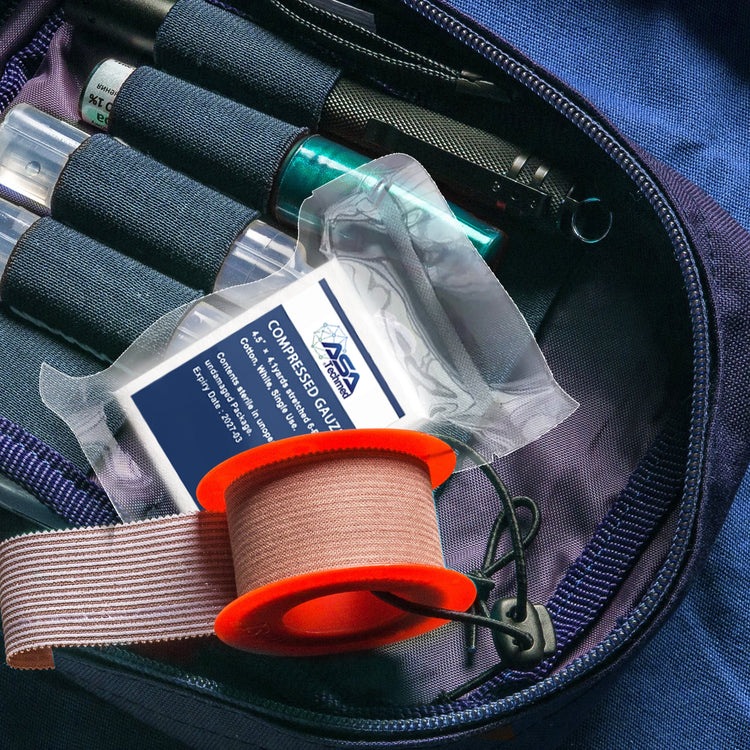A lifestyle shot showing the compact gauze package stored inside an open tactical first aid kit or medical bag, sitting next to a roll of medical tape and other emergency supplies.
