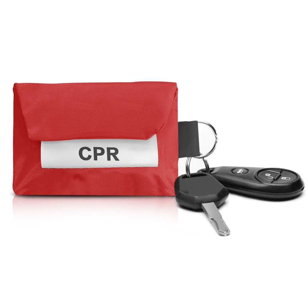 A red CPR pouch attached to a car key fob and ignition key via its metal ring, showing its utility as a keychain.