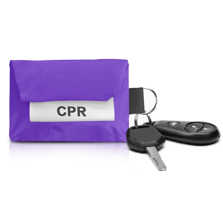 A purple CPR pouch attached to a car key fob and ignition key via its metal ring, showing its utility as a keychain.