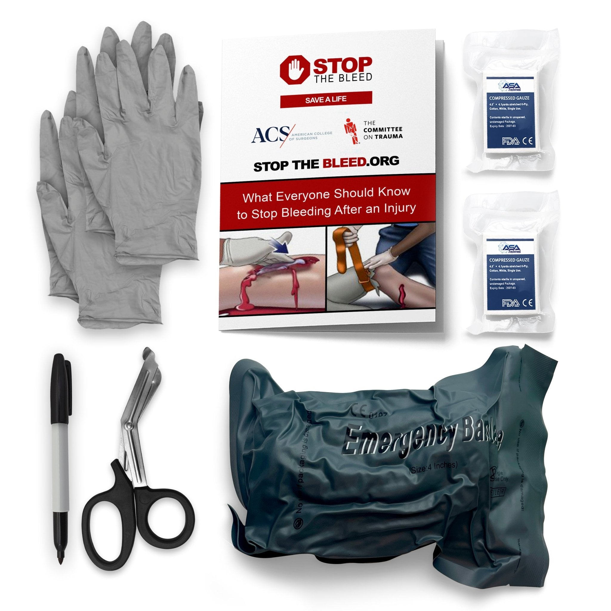 A clear overhead shot of the complete emergency trauma kit contents arranged on a white background. The items include a stack of grey medical gloves, a "Stop the Bleed" instructional booklet, two white packages of compressed gauze, a black permanent marker, black trauma shears, and a vacuum-sealed green package containing an emergency bandage.