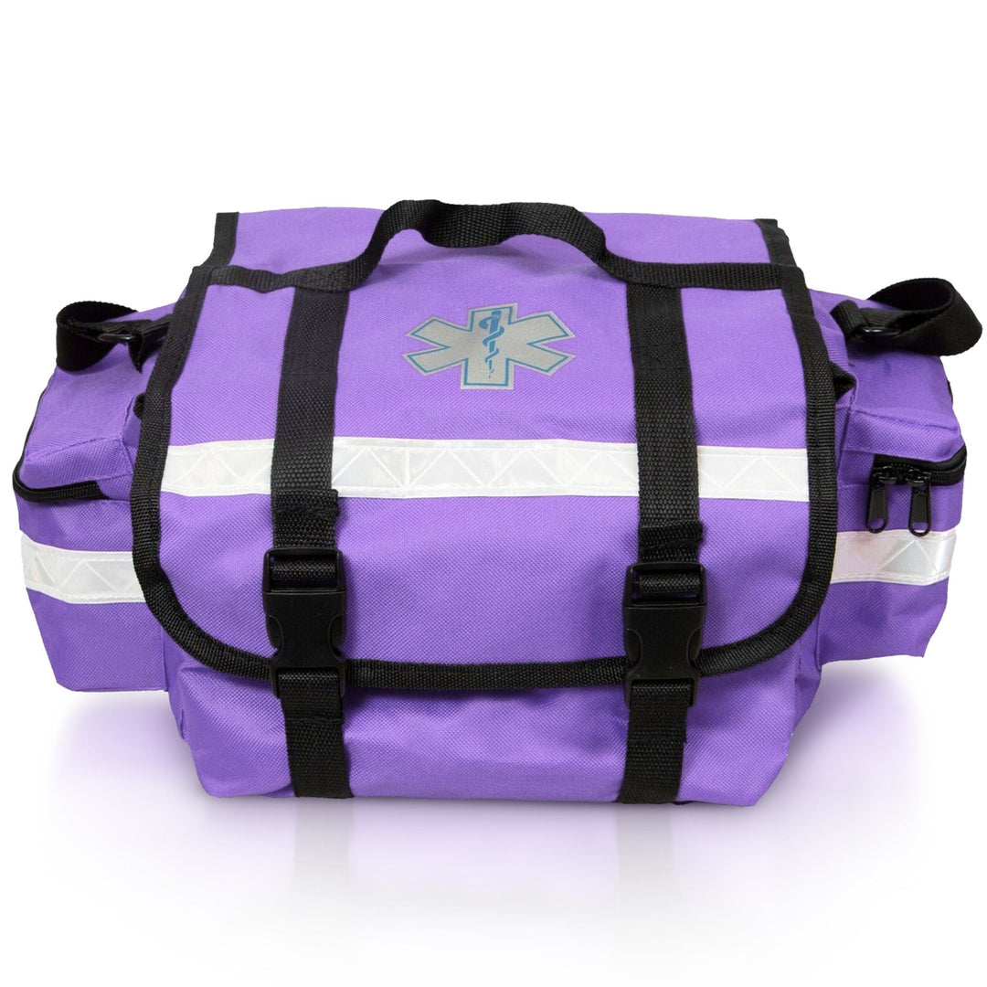 A straight-on front view of the purple EMT trauma bag. It features a central Star of Life symbol, two black straps with buckles securing the top flap, and a prominent reflective strip running horizontally across the front.