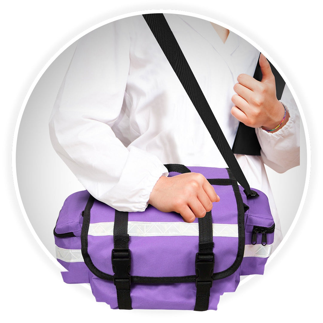 A close-up of a medical professional wearing a white coat, carrying the purple bag. They are holding the top handle with one hand while the adjustable black shoulder strap rests across their body.