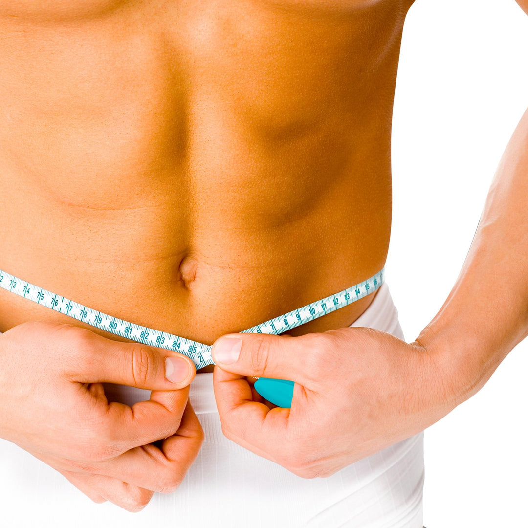 Close-up of a shirtless person measuring their waist circumference with a white and turquoise body measuring tape.