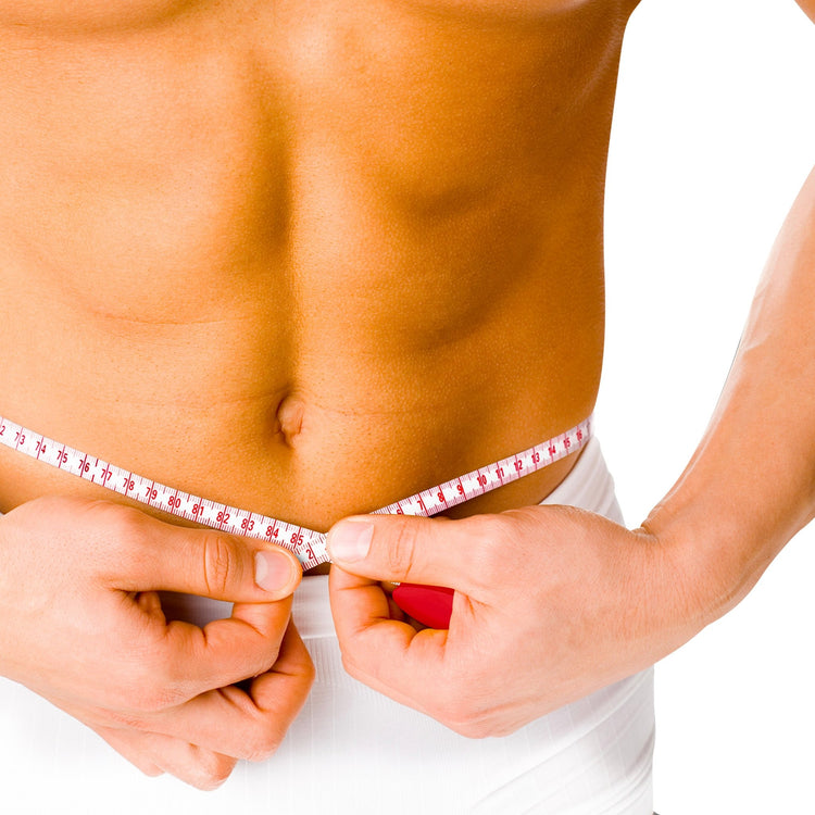 Close-up of a shirtless person measuring their waist circumference with a white and red body measuring tape.