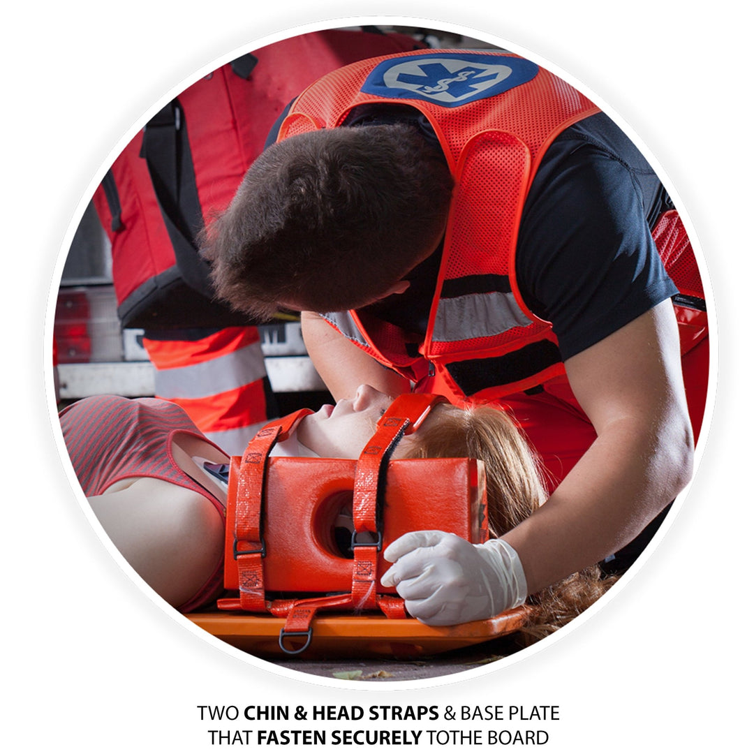 EMS provider securing a patient in the red head immobilizer. Text reads: Two Chin & Head Straps & Base Plate that fasten securely to the board.
