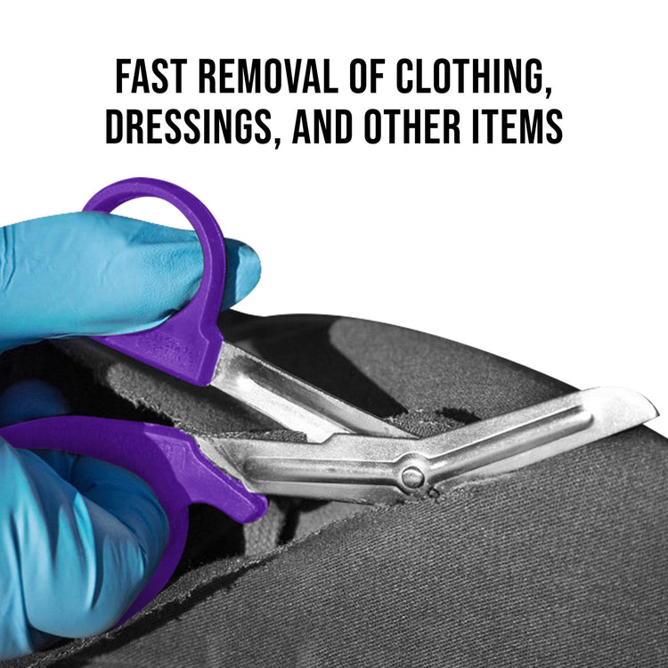 A pair of purple shears held by blue-gloved hands cutting through thick black fabric. Text above reads, "FAST REMOVAL OF CLOTHING, DRESSINGS, AND OTHER ITEMS".