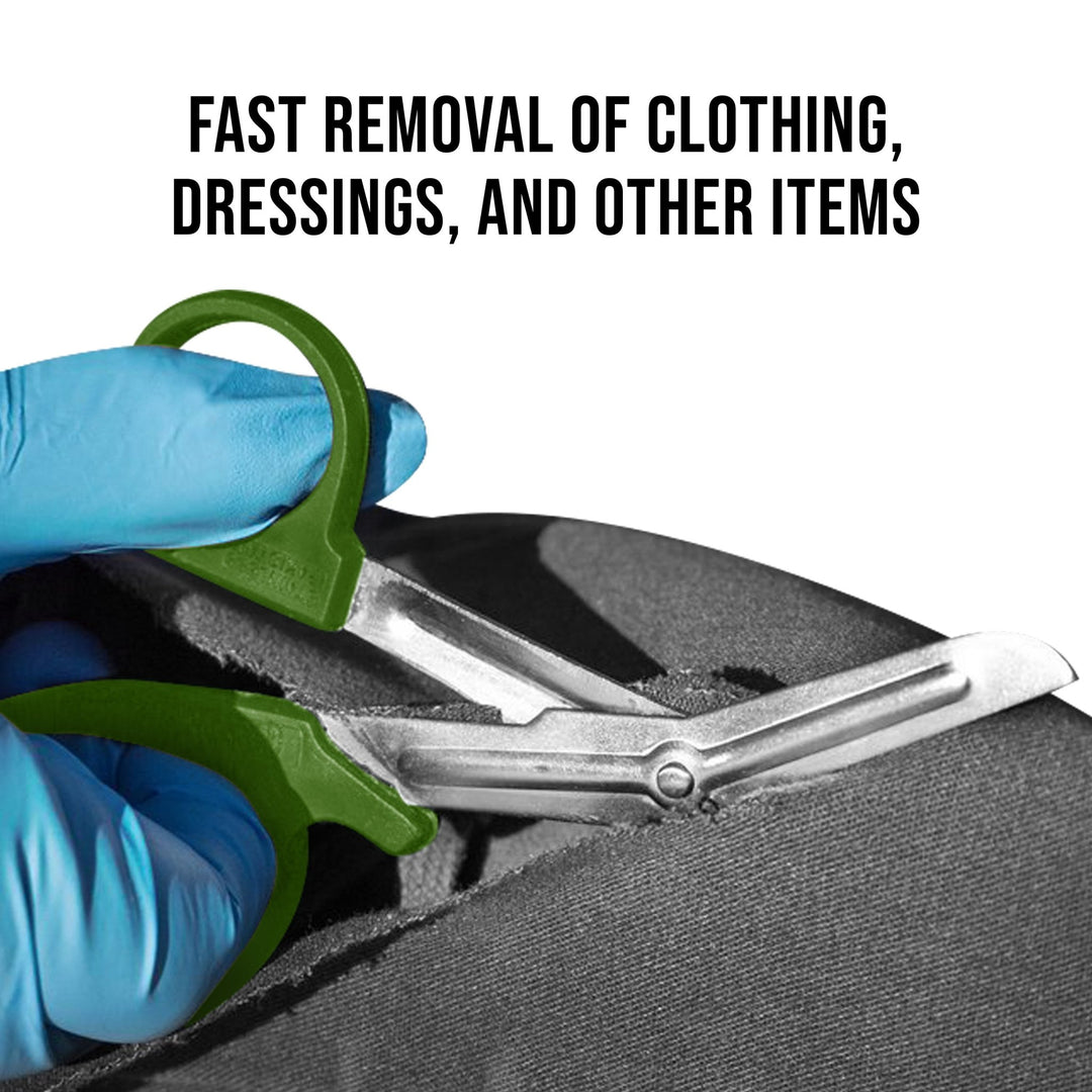 A pair of olive green shears held by blue-gloved hands cutting through thick black fabric. Text above reads, "FAST REMOVAL OF CLOTHING, DRESSINGS, AND OTHER ITEMS".