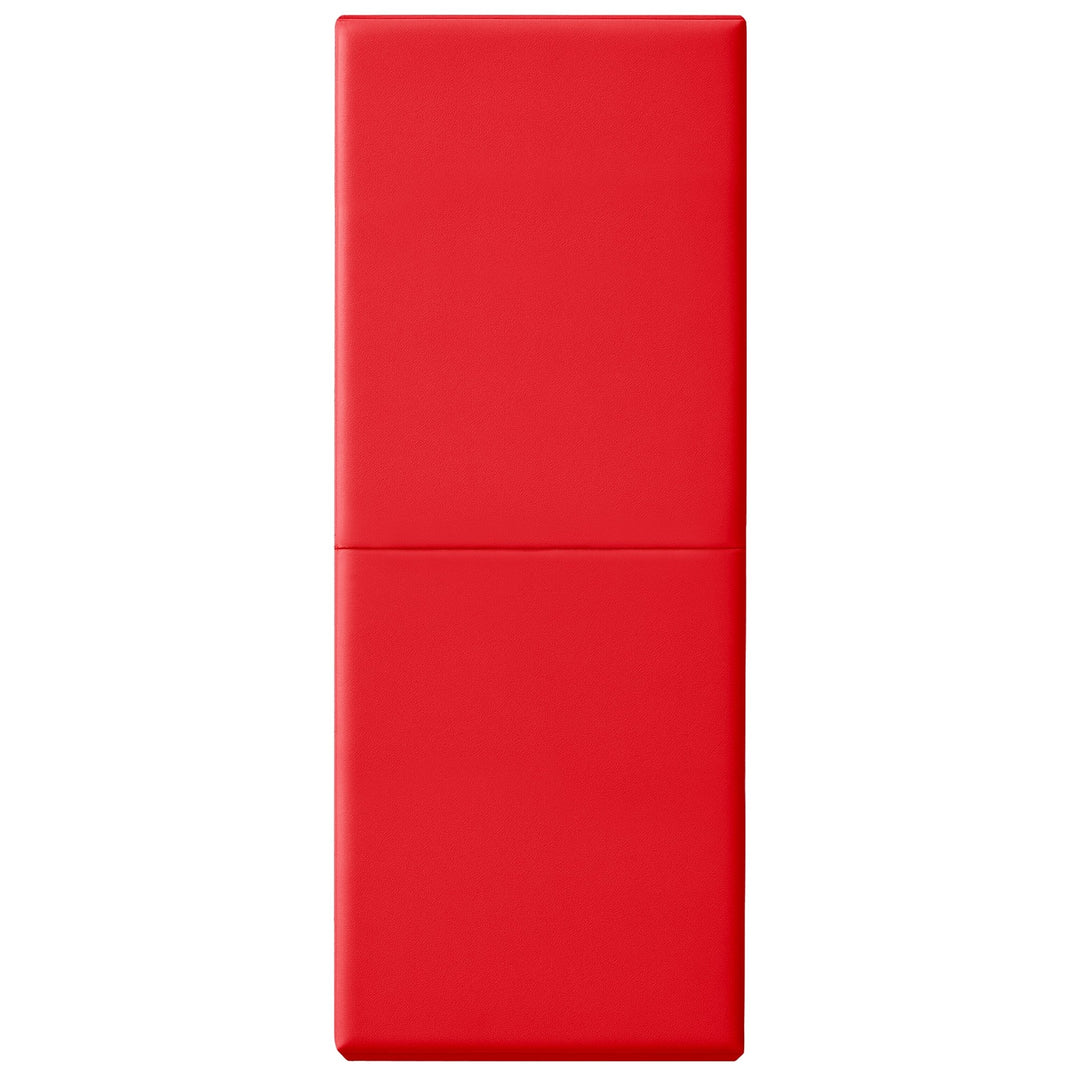 A vertical studio shot of a red safety wall pad fully extended, showing the smooth vinyl texture and the horizontal crease in the center where the mat folds.