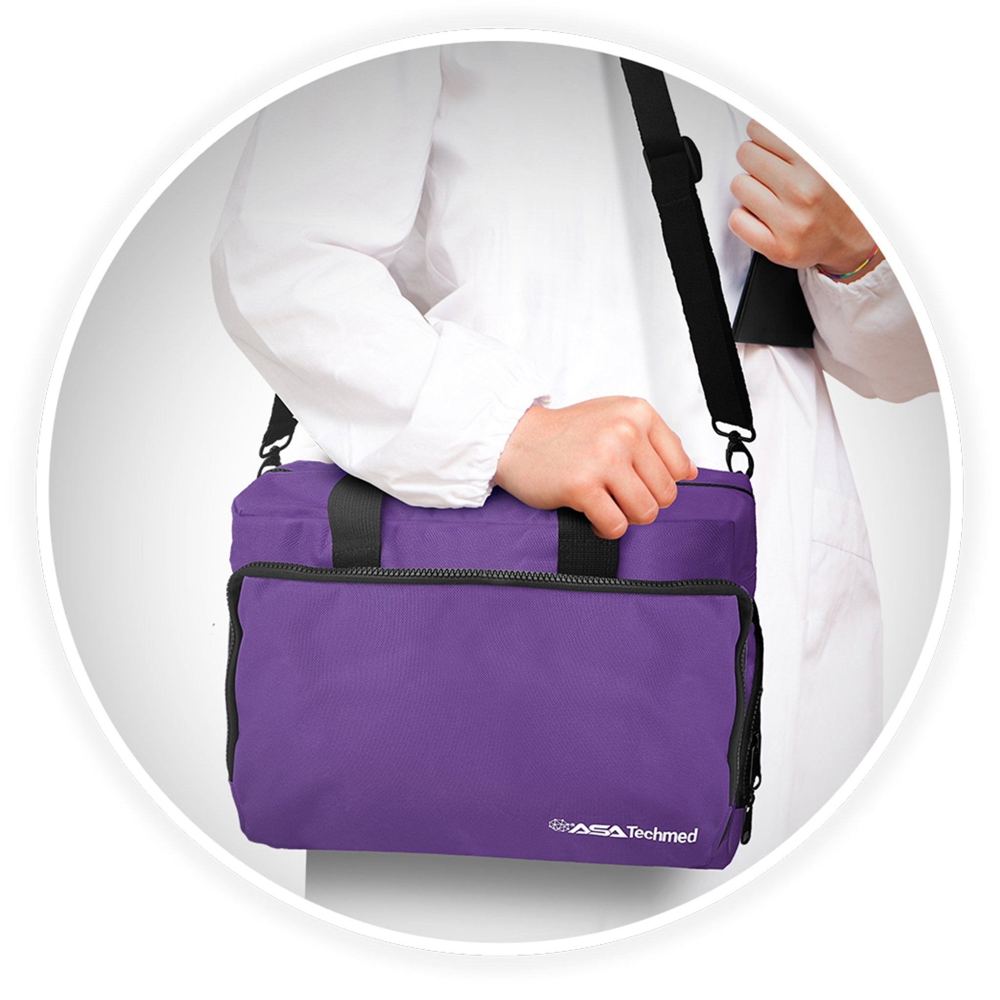 A close-up shot of a person's hand holding the black webbed handle of the purple medical bag, demonstrating its portability and ease of carrying.