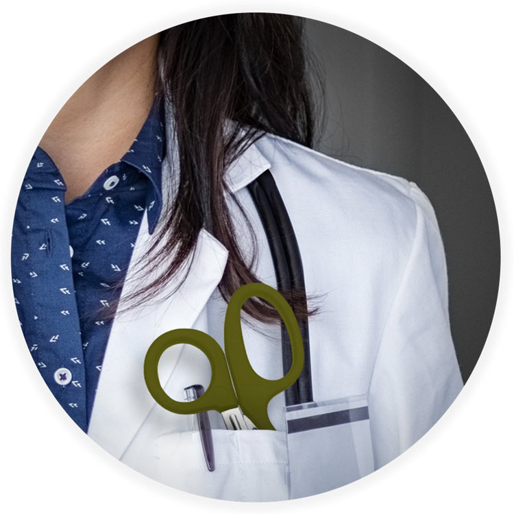 A close-up lifestyle image showing a medical professional in a white coat with a stethoscope, featuring green trauma shears tucked into their chest pocket.