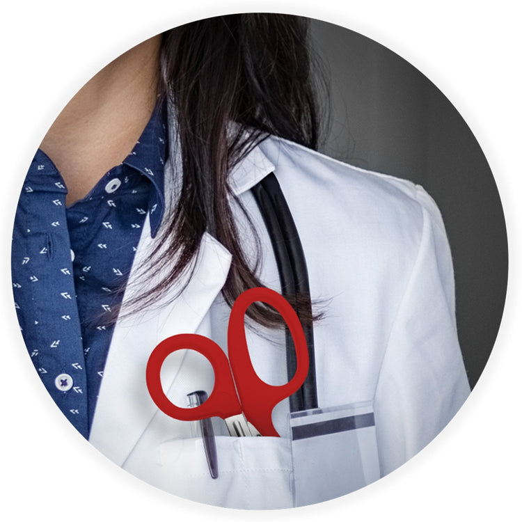 A close-up lifestyle image showing a medical professional in a white coat with a stethoscope, featuring red trauma shears tucked into their chest pocket.