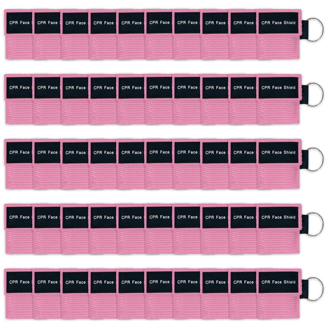 A bulk package display of fifty pink CPR face shield keychains arranged neatly in five rows of ten, suitable for training or large groups.