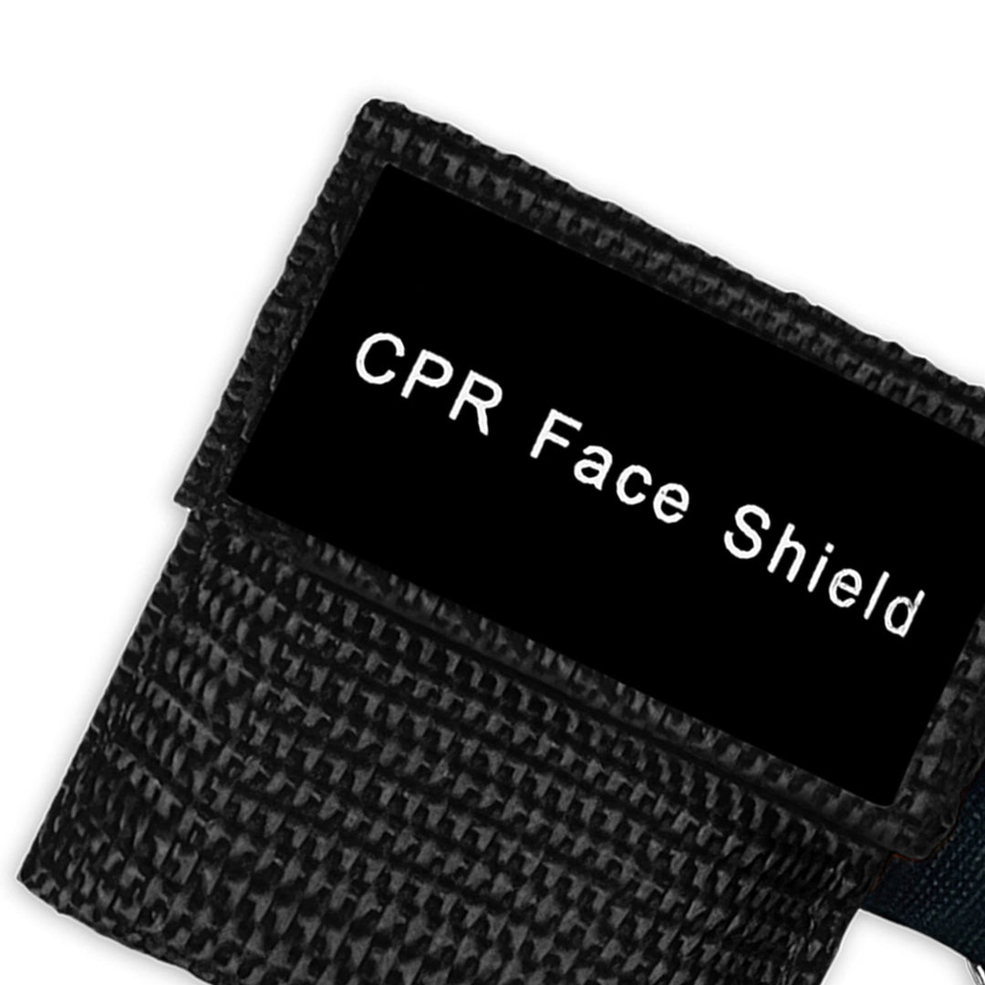 A top-down close-up view of a single black CPR keychain pouch, highlighting the woven fabric texture and the black identification label.