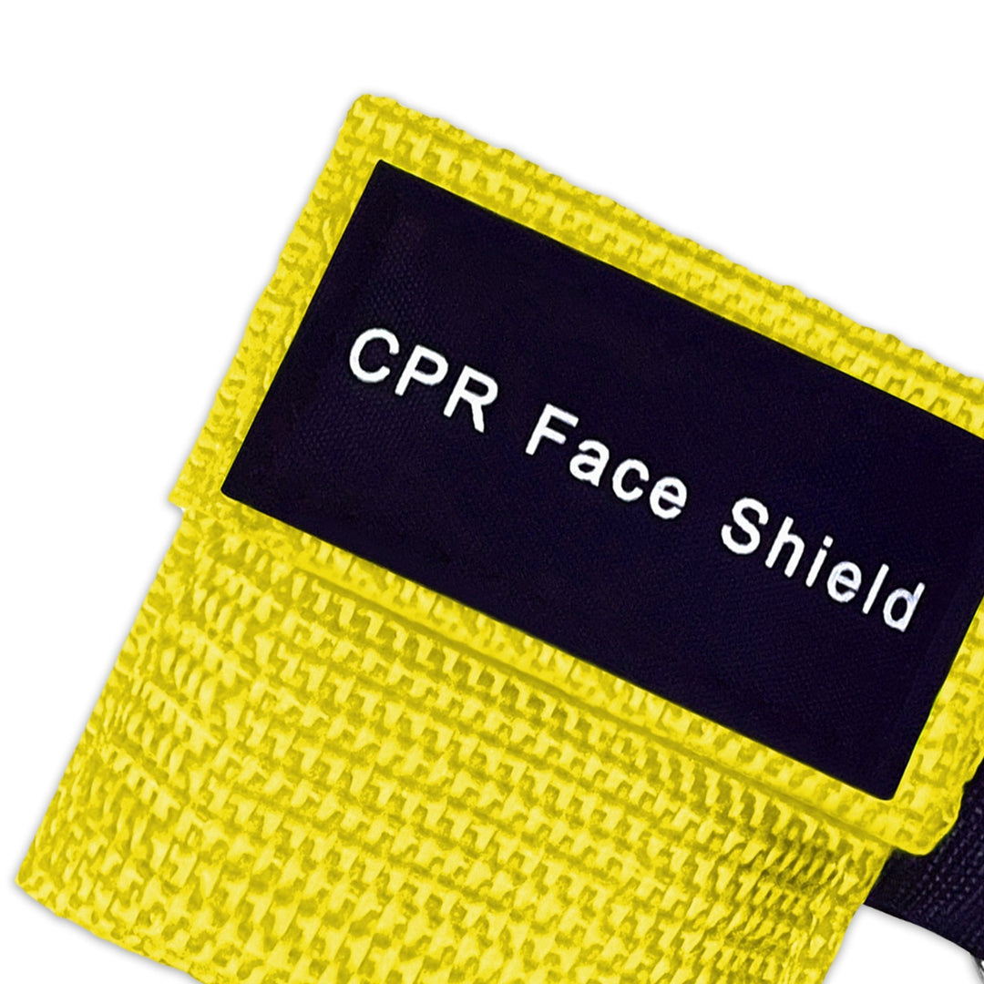 A top-down close-up view of a single yellow CPR keychain pouch, highlighting the woven fabric texture and the black identification label.