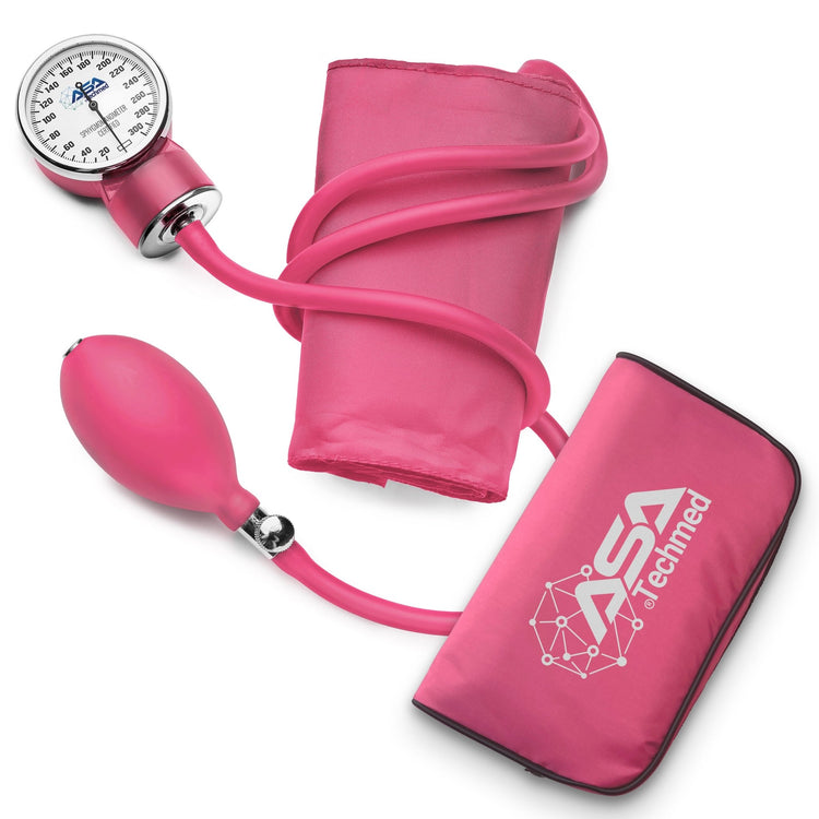 Flat lay of the pink blood pressure monitor components: gauge, cuff, bulb, and case.